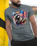Patriotic Raccoon with USA Flag T-shirt - model leaning on yellow-black pole, wearing Gray T-shirt, hand in pocket