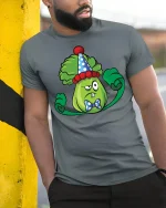 Grumpy Lettuce in Clown Hat Tee - model leaning on yellow-black pole, wearing Gray T-shirt, hand in pocket