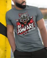 Be Awware Wolf Graphic Tee - model leaning on yellow-black pole, wearing Gray T-shirt, hand in pocket