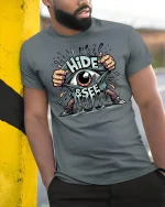 Hide and Seek Eye Tee - model leaning on yellow-black pole, wearing Gray T-shirt, hand in pocket