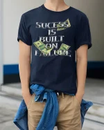 Success Built on Failure Money Quote T-shirt - model wearing Navy T-shirt, hands in pockets, denim shirt at waist