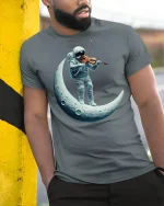 Astronaut Playing Violin on the Moon T-Shirt - model leaning on yellow-black pole, wearing Gray T-shirt, hand in pocket