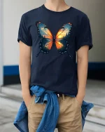 Sunset Forest Butterfly Nature Art Graphic T-Shirt - model wearing navy tee with hands in pockets
