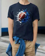 Splash Football Art Cool Sports Fan Game Day T-Shirt - model wearing navy tee with hands in pockets