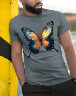 Sunset Forest Butterfly Nature Art Graphic T-Shirt - model wearing grey tee, leaning on column