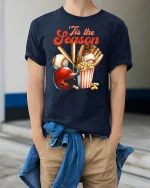 ’Tis The Season Baseball Fan Funny T-Shirt - model wearing Navy T-shirt, hands in pockets, denim shirt at waist