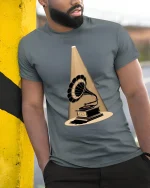 Vintage Gramophone Spotlight Graphic T-Shirt Retro Art - model leaning on yellow-black pole, wearing Gray T-shirt, hand in pocket