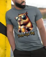 Brew-tiful Day Capybara Beer Lover Funny T-Shirt - model leaning on yellow-black pole, wearing Gray T-shirt, hand in pocket