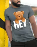 Hey Teddy Bear T-Shirt - Cute Smiling Bear Graphic Tee - model wearing grey tee, leaning on column