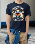 Positive for Faith in Jesus T-Shirt Bible Butterfly Graphic Tee - model wearing navy tee with hands in pockets