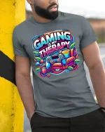 Gaming Is My Therapy Graphic T-Shirt for Gamers Comfort Fit - model wearing grey tee, leaning on column