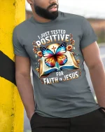 Positive for Faith in Jesus T-Shirt Bible Butterfly Graphic Tee - model wearing grey tee, leaning on column