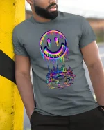 Neon Drip Smiley Tee - Vibrant Melted Rainbow Streetwear - model wearing grey tee, leaning on column