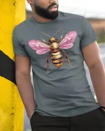 Pink Winged Golden Bee Art Tee for Nature Lovers - model wearing grey tee, leaning on column