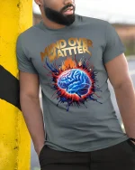 Mind Over Matter Motivation Tee with Exploding Brain Graphic Art - model wearing grey tee, leaning on column