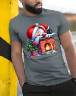 Funny Santa Stuck on Chimney Christmas Tee for Holiday Fun - model wearing grey tee, leaning on column