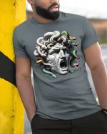 Medusa Stone Head Mythical Monster Graphic T-Shirt - model wearing grey tee, leaning on column