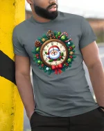 Santa Clock Christmas Wreath Graphic T Shirt Festive Holiday Tee - model wearing grey tee, leaning on column