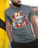 Cute Christmas Kitten With Gift Boxes Graphic T Shirt Cozy Tee - model wearing grey tee, leaning on column