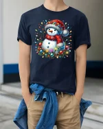 Cute Christmas Snowman With Lights Graphic T Shirt Festive Cheer Tee - model wearing navy tee with hands in pockets