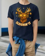 Sleighin’ It Cool Reindeer Sunglasses Funny Christmas Graphic Tee - model wearing navy tee with hands in pockets