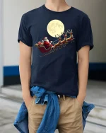 Santa Sleigh Moonlight Ride Classic Christmas Graphic T-Shirt - model wearing navy tee with hands in pockets