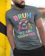 Bruh We Are Glowing Neon Bear Funny Retro Style Graphic Tee - model wearing grey tee, leaning on column