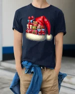 Festive Santa Hat Gift Stack Tee With Cozy Holiday Cheer - model wearing navy tee with hands in pockets