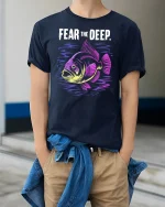Fear The Deep Neon Fish Graphic Tee Tshirt - model wearing navy tee with hands in pockets