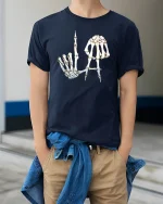 Skeleton Hand Letter Art Dark Humor Graphic Tee Tshirt - model wearing navy tee with hands in pockets
