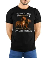 Never Stand Between A Woman And Her Dachshunds Tee Tshirt - model wearing black tee with hands behind back