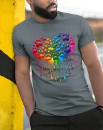 Rainbow Paw Heart Dripping Love Pride Graphic Tee Tshirt - model wearing grey tee, leaning on column