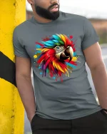 Colorful Macaw Parrot Splash Art Graphic T Shirt Bold Tee - model wearing grey tee, leaning on column