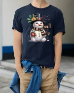 Cute Snowman Winter Holiday Tshirt With Cozy Scarf And Sweet Smile - model wearing navy tee with hands in pockets