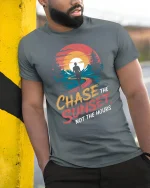 Chase The Sunset Not The Hours Inspirational Adventure Graphic Tshirt - model wearing grey tee, leaning on column