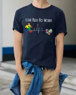 Love Need No Words Autism Puzzle Heartbeat Graphic T Shirt - model wearing navy tee with hands in pockets