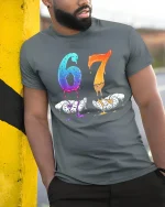 Dripping 67 Number Art Graphic T Shirt With Bold Creative Style - model wearing grey tee, leaning on column