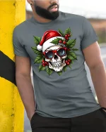 Cool Santa Skull Christmas Graphic T-Shirt for Holiday Fun - model wearing grey tee, leaning on column