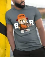 Cool Skater Bear Tee with Streetwear Style and Cute Bear Graphic - model wearing grey tee, leaning on column