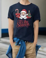 Cute Santa Tis the Season Christmas Cheer Graphic T-Shirt - model wearing navy tee with hands in pockets