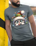Cute Christmas Kitten Lights Beanie Holiday Cartoon Graphic T-Shirt - model wearing grey tee, leaning on column