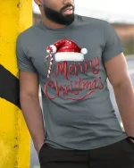 Merry Christmas Santa Hat Candy Cane Festive Holiday Tee - model wearing grey tee, leaning on column