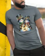 Charming Snowman Couple Tee with Cozy Winter Lantern Artwork - model wearing grey tee, leaning on column