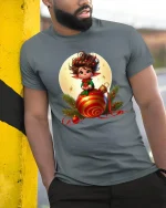 Cute Christmas Elf Sitting On Ornament Festive Graphic Tee - model wearing grey tee, leaning on column
