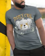 Dont Cry Money Teddy Bear T Shirt With Bold Street Attitude - model wearing grey tee, leaning on column