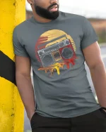 Retro Boombox Sunset Graphic Tee Vintage Music Art T Shirt - model wearing grey tee, leaning on column