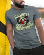 BagBoyz Entertainment Money And Music Street Graphic T Shirt - model wearing grey tee, leaning on column