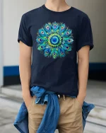 Colorful Peacock Mandala Graphic Tee Vibrant Feather Art - model wearing navy tee with hands in pockets
