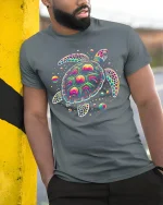 Psychedelic Sea Turtle Graphic Tee Colorful Cosmic Art - model wearing grey tee, leaning on column