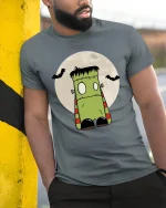 Cute Frankenstein Monster Graphic Tee Funny Spooky Cartoon - model wearing grey tee, leaning on column